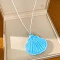 Detailed macro view of the light blue leather shell-shaped eyewear clip necklace. - Shell Shape (With Eyewear Holder) / Blue