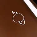 Close-up of minimalist silver heart-shaped pendant chain ring with adjustable pull mechanism - Hollow Heart Pendant Chain Style (HR3952) / Silver