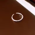 Detail shot of a minimalist silver open ring with 100 percent battery engraving - 100% Battery Engraving Style (HR3951) / Silver