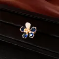 Elegant gold plated flower ring featuring deep blue teardrop zircons and white crystals - Ring / Gold with Blue