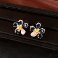 Elegant flower stud earrings with blue and white zircons in real gold plating finish - Stud Earrings (Silver Pin) / Gold with Blue