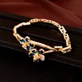 Elegant gold plated bracelet featuring two exquisite blue zircon flower charms for women - Bracelet / Gold with Blue