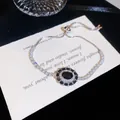 Gros plan d'un bracelet en argent rétro avec pierre ovale noire et zircons scintillants. - Argent Zircone Noir / Argent