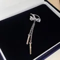 Detailansicht einer silbernen Schleifen-Ohrmanschette mit funkelnden Steinen in der Box. - Schleife-Stil / Einzelstück / Silber
