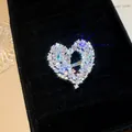 Close-up detail of a sparkling hollow heart ring with encrusted cubic zirconia - Silver