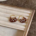 Detailed view of 18k gold plated earrings with brown enamel and white polka dots - Ear Hook - Gold - Brown