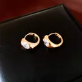 Macro view of 18K gold plated round hoop earrings with sparkling zircon stones - Gold (18K Gold Plated)