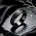 Macro view of black rotatable stainless steel ring with keep fucking going engraving - Black