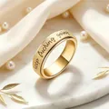 Close-up detail of a gold stainless steel rotatable ring with keep fucking going engraving - Gold