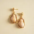 Detailed view of vintage irregular resin earrings with gold-toned metal accents. - Beige