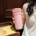 Detailed macro view of a pink 316 stainless steel coffee tumbler with dual-drink lid design - 550ml / Pink
