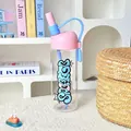 Detailed view of a trendy pink and blue high borosilicate glass water bottle with straw - 790ml / Pink Lid