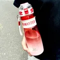 Detailed view of a gradient red sports water bottle with scale markings held by hand. - 950ML / Red White Gradient