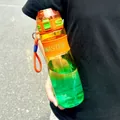 Handheld gradient sports water bottle with scale and orange carry strap detail - 950ML / Orange-Green Gradient