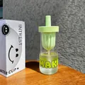 Detail view of a glass tea infuser water bottle with a light green separator lid - 600ml / Green