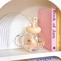 Close-up of chubby glass cup with donut lid, built-in tea filter and cute bear straw - 1100ML / White