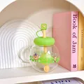 Close-up of a cute spherical glass tea cup with straw and filter in a cozy shelf setting - 1100ML / Green