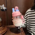 Detail of cartoon glass water bottle with pink lid and cute figurine accessory - 500ml / Pink