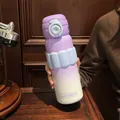 Close-up of a purple and white gradient insulated bottle with a blue silicone grip - 580ml / Purple