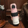 Detail of a pink gradient stainless steel vacuum flask with a black silicone grip sleeve - 580ml / Pink