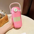 Detailed view of a pink stainless steel vacuum flask with straw and carrying handle - 500ml / Pink