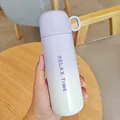 Portable lavender gradient stainless steel thermos bottle held in hand - 500ml / Purple