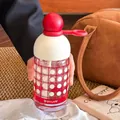 Glass water bottle with red ball lid, checkered pattern and built-in straw for students - 310ml / White And Red