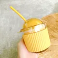 Close-up of a cute yellow egg-shaped glass straw cup with silicone sleeve - 350ml / Yellow