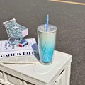 Close-up of a stylish blue gradient double-wall plastic straw cup on a white box - 750ml / Sky Blue