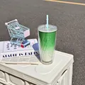 Detailed view of a green gradient double-layer plastic straw cup with star patterns. - 750ml / Green