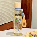 Cute clear plastic straw water bottle with colorful polka dots and an orange strap - Yellow