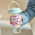 Portable glass water bottle with pink polka dot sleeve, tea infuser and light blue lid - 620ml / Blue Lid