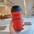 Close-up of a red stainless steel sports water bottle with a dual-drink lid. - 500ml / Red