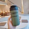 Close-up of green stainless steel sports water bottle with a dual-use drinking lid. - 500ml / Dark Green
