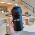 Close-up of a hand holding a black matte stainless steel sports water bottle - 500ml / Black