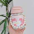 Close-up detail of a pink glass tulip water bottle featuring a decorative pearl handle chain - Pink (BSQ529) / 400ml