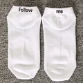 Detailed view of white cotton boat socks featuring 'Follow me' black letter embroidery. - One Size / FOLLOW ME / White