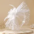 Elegant white bridal fascinator with mesh polka dots and feathers on clear stand - White