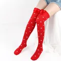 Detailed view of red over-the-knee socks with white heart patterns and silk bows. - One Size / Red Socks With White Heart Pattern And Red Bow