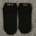 Close-up detail of black ankle socks featuring white Uncle Sam embroidered text design - One Size / UNCLE SAM / Black