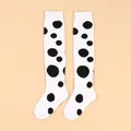 Detailed view of white over-the-knee children's socks with large black polka dots - Children (4-7 Years) / White with Black Dots