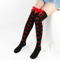 Close-up of over-the-knee black socks with red lips pattern and red bowknot details - One Size / Black Socks With Red Lip Print And Red Bow