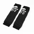 Macro view of black knitted leg warmers featuring white skull and polka dot patterns - One Size / Black