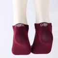 Detailed view of maroon ankle socks featuring a knitted 'Fuck Off' prank slogan on heels - One Size / FUCK OFF / Burgundy