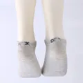 Close-up detail of grey low-cut socks featuring funny letter print on the heel rim - One Size / FUCK OFF / Gray