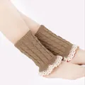 Detailed close-up of brown cable knit leg warmers featuring delicate white lace trim on feet - One Size / Khaki