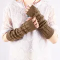 Close-up of brown cable knit arm warmers on a model's arms - Khaki