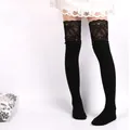 Detailed view of black knitted over-the-knee socks featuring elegant lace floral trim. - One Size / Black