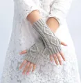 Close-up of grey cable knit fingerless gloves showing intricate texture and weave. - One Size / Light Gray