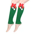 Close-up view of festive green knitted Christmas leg warmers with red bows and pom-poms - One Size / Green